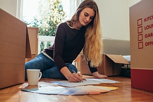 woman making chore list on how to sell your house