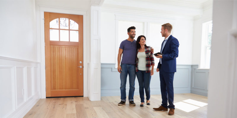 a couple working with a real estate agent after learning how to choose one