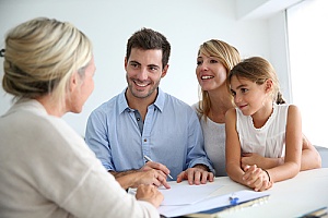 a family working with a real estate agent to understand what they do during the home selling process