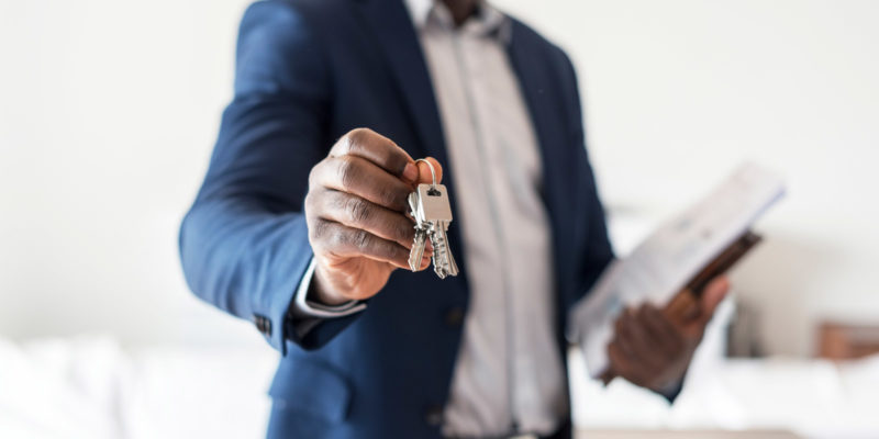 a real estate agent holding the keys to a house