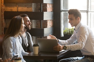 couple talking to real estate agent about the real estate market trends they are concerned about