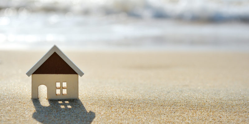miniature wooden house on a beach