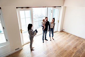 a family at an open house with a real estate agent