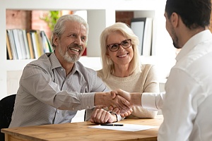 Retired couple talking to real estate agent 