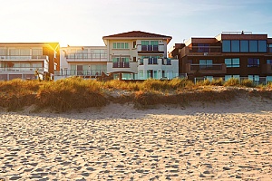 a row of beach houses right along the oceanfront