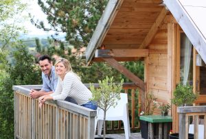 happy couple on beach house balcony deciding to buy a second home