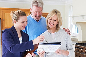 a couple speaking with an experienced listing agent during an open house