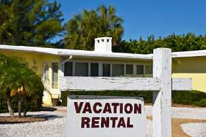 A Vacation Rental Sign. Various factors may impact your cap rate on Investment Property