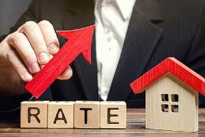 A man holding an arrow upward depicting a good cap rate for an investment property