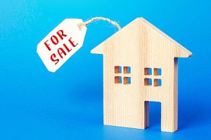 House figure with a price tag. A listing agent can assist you with a home sale