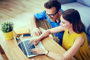 couple looking at real estate listings on their computer